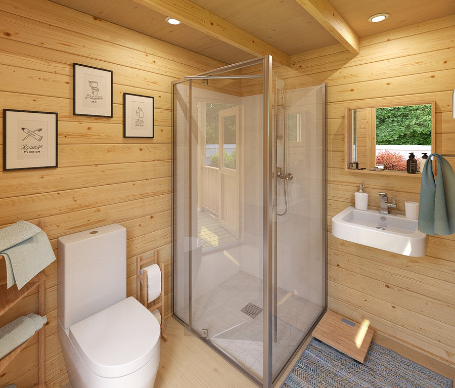 Innerhalb eines Badezimmers mit Holzwänden befinden sich eine Toilette, eine Duschkabine und ein Waschbecken.