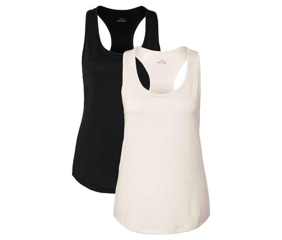 Zwei Tanktops, eines schwarz und eines cremefarben, liegen nebeneinander.