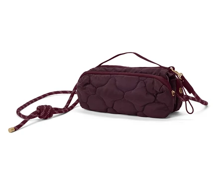 Nahaufnahme einer gesteppten, kastanienbraunen Handtasche mit Kordelzug.