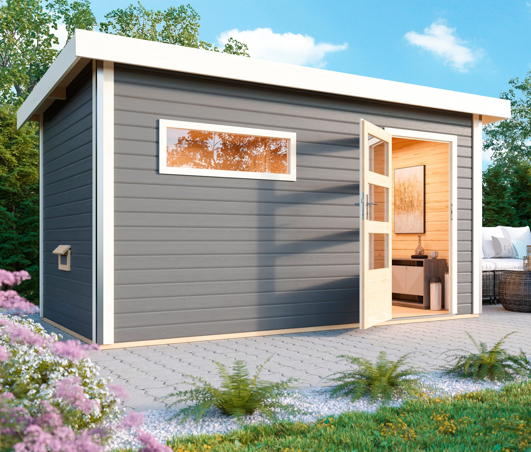 Graues Saunahaus mit offener Tür steht auf einer Terrasse neben Gartenmöbeln.