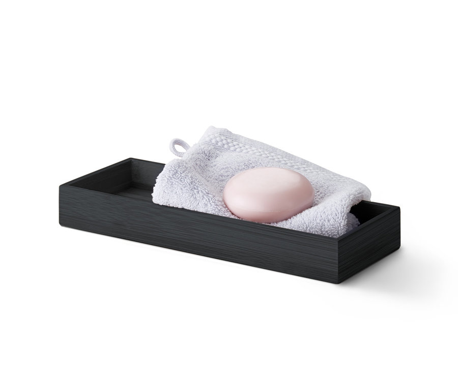 Schwarzes Tablett mit Handtuch und Seife.