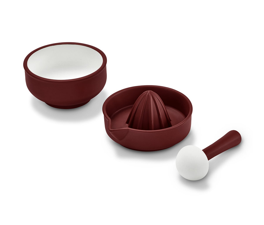 Abgebildet ist ein 2-in-1: Mörser und Zitruspresse in Burgunderrot, wobei das Innere des Mörsers und das Ende des Stößels weiß sind.
