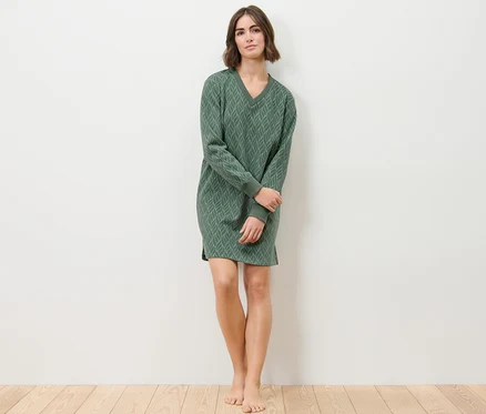 Frau steht und trägt ein Loungewear-Kleid.