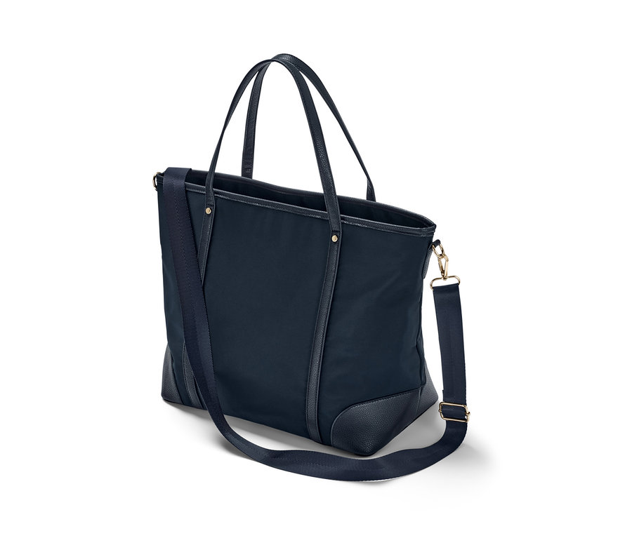 Eine marineblaue Shopper Tasche mit Henkel und Schultergurt.