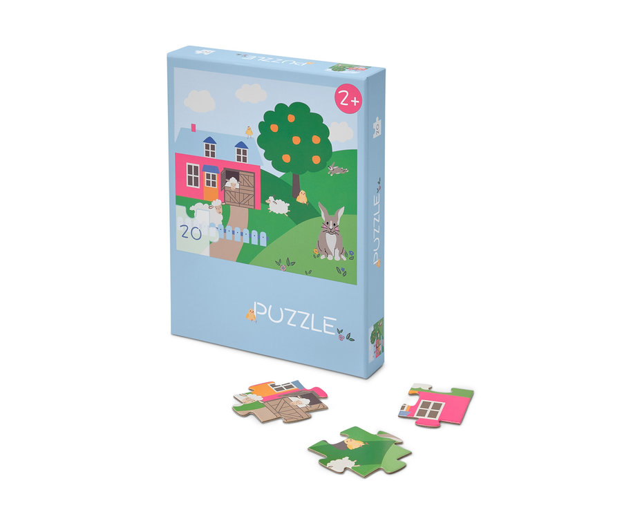 Eine Packung des »Ostern« Puzzles, mit einigen Puzzleteilen darunter ausgelegt.