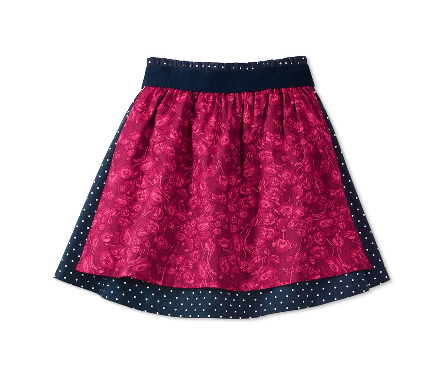 Rock mit Wendeschürze mit Blumenmuster und dunkelblauem Saum mit weißen Punkten.