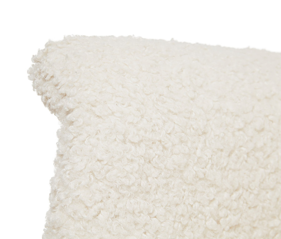 Detailaufnahme des Bouclé-Stoffs eines Schaukelstuhls.
