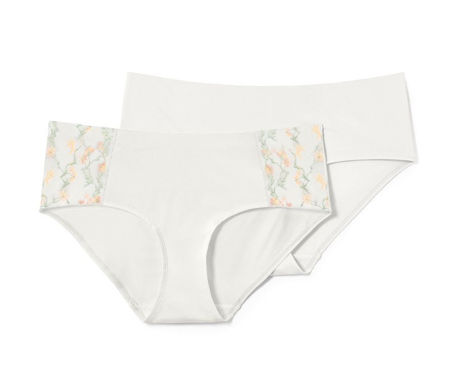 Zwei weiße Pantys, eine davon mit Blumenmuster.