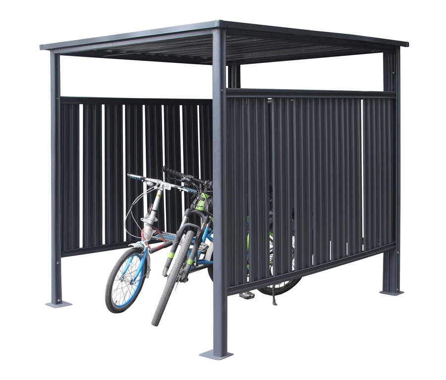 Zwei Fahrräder stehen in einem grauen Fahrradunterstand.