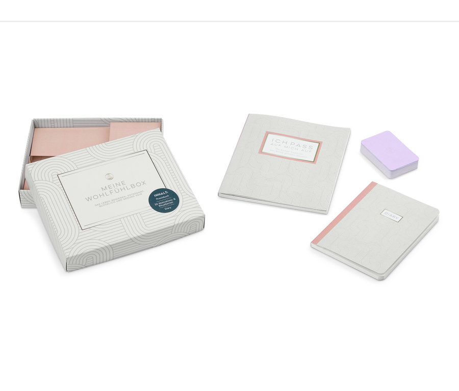 Geöffnete Meine Wohlfühlbox neben Tagebuch, Motivationskarten und Ritualkarten.
