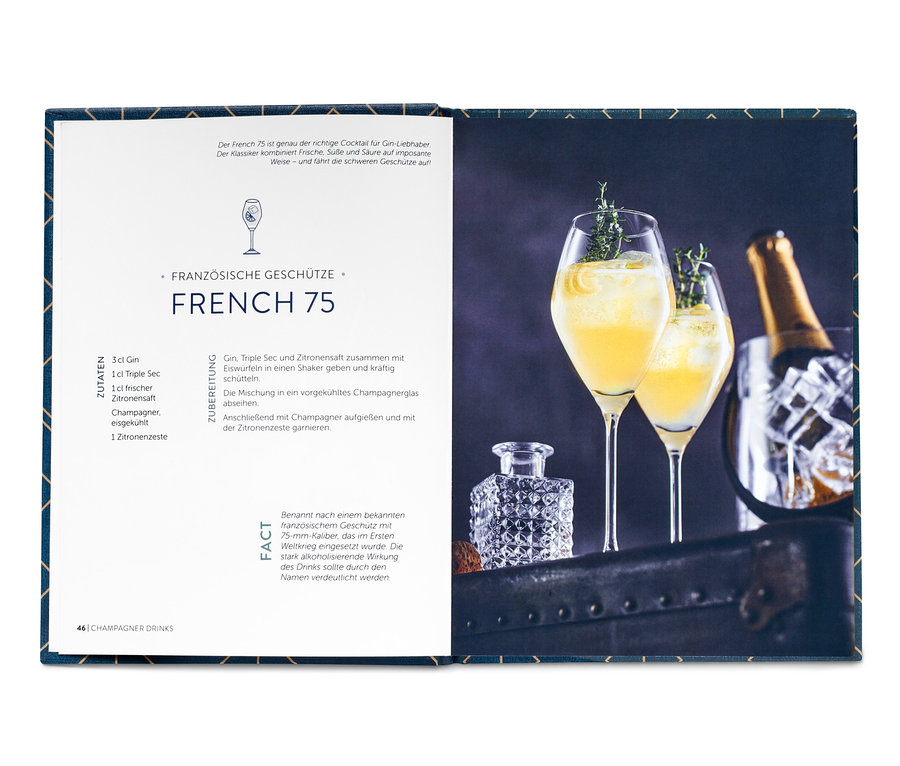 Buch "Cocktails & Drinks" mit zwei Gläsern French 75 Cocktail, einer Champagnerflasche im Kühler und einem Kristallbehälter.