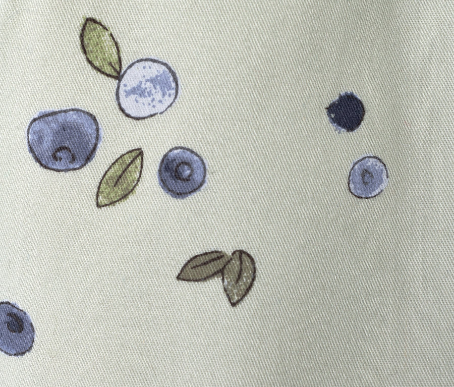 Nahaufnahme des Musters einer Kinder-Pull-on-Pants – Fit »Ella«, Beeren auf hellgrünem Stoff.