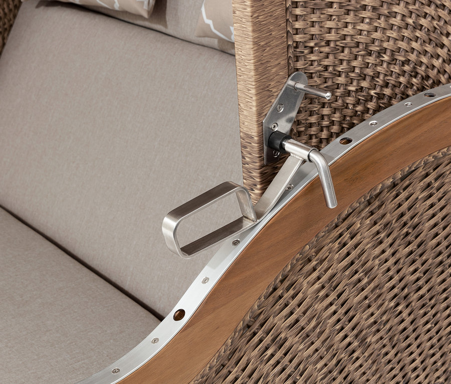 Detailansicht eines Premium-Strandkorbs XXL mit 2 Ausklapptischen, der das geflochtene Äußere, Holzakzente und beige Kissen zeigt.