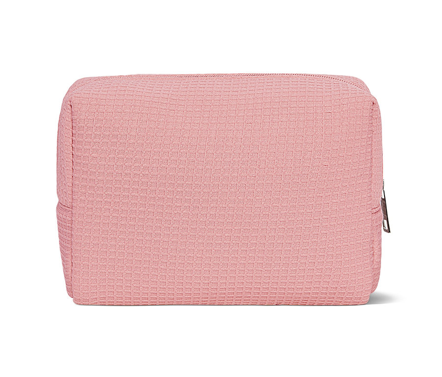 Eine rosafarbene Kulturtasche auf weißem Hintergrund.