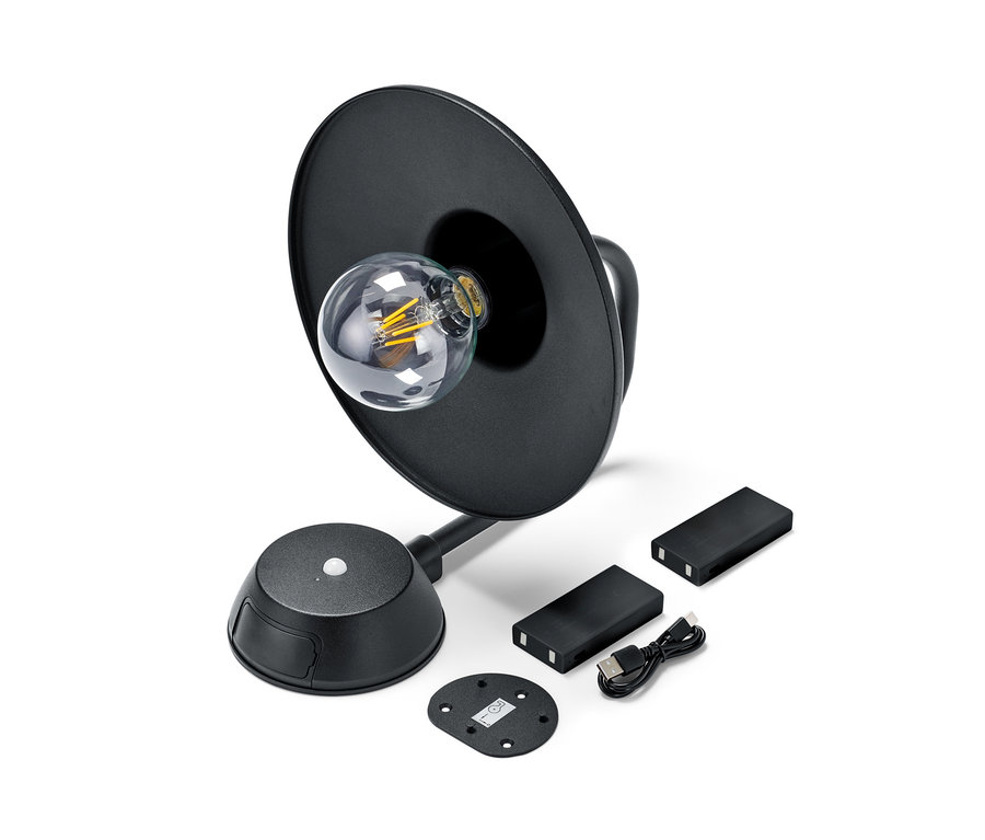 Schwarze LED-Akku-Wandleuchte mit Wechselakku und Zubehör.