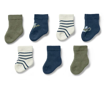 Sieben Paar Baby-Socken mit Drachenmotiv.