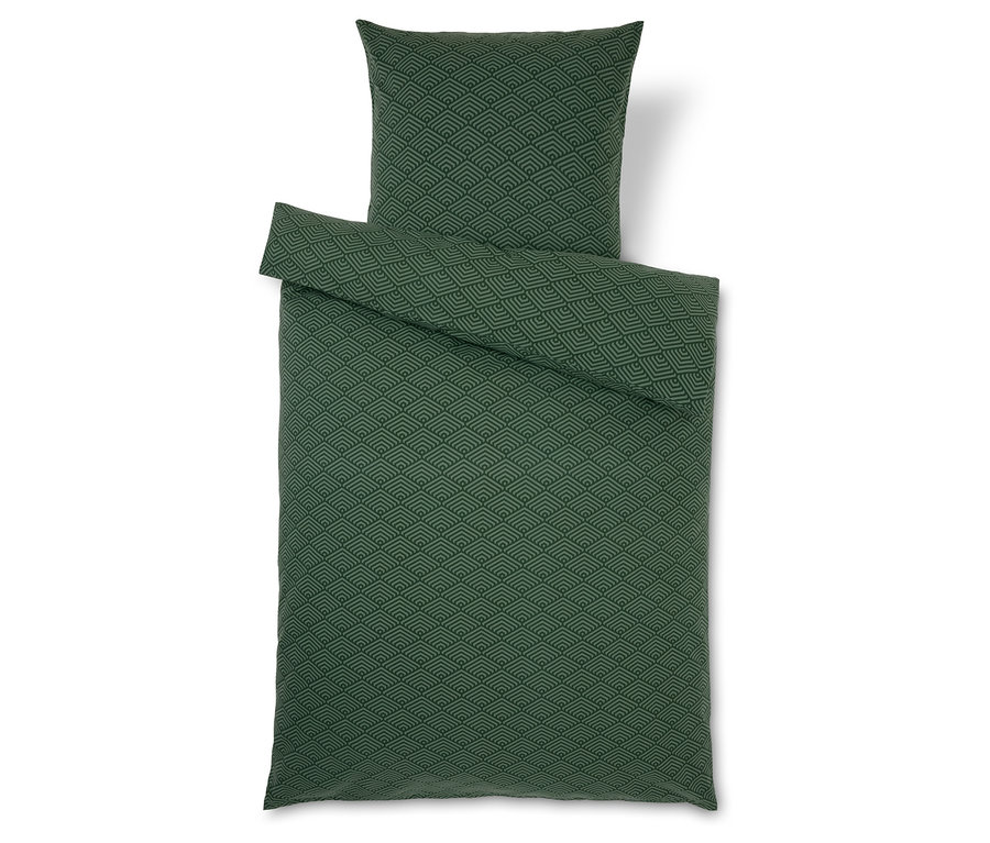 Grüne Bettwäsche mit geometrischem Muster.