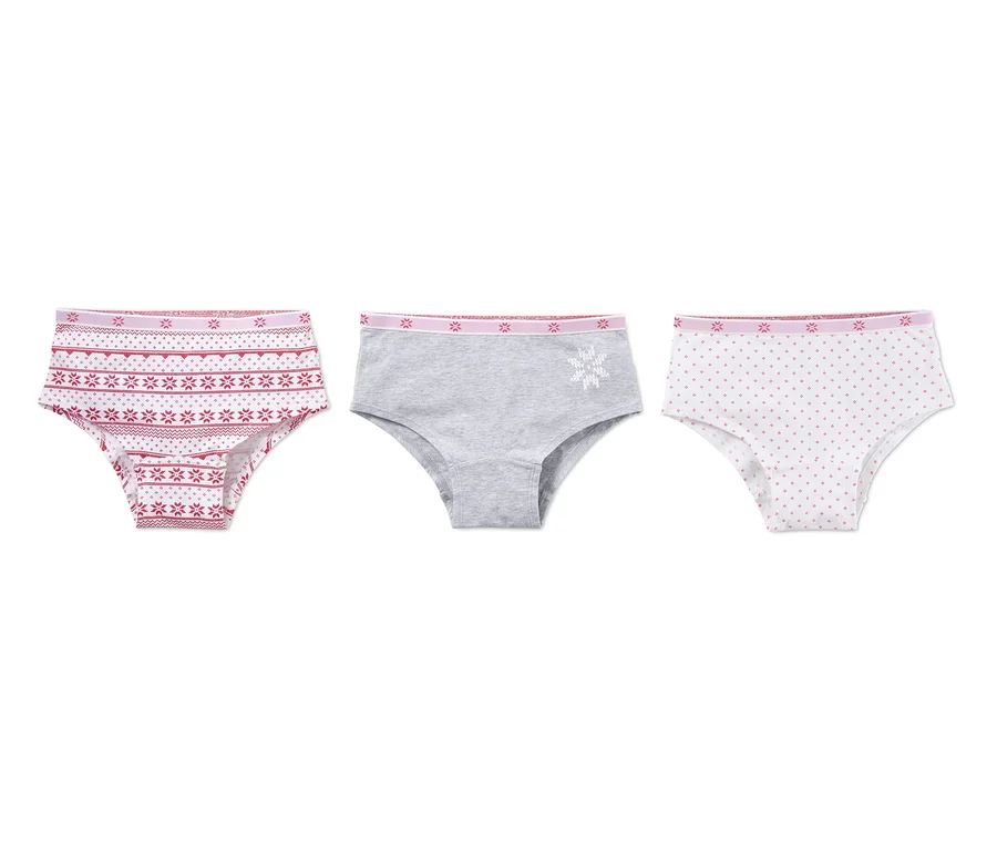 Drei Pantys: Eine mit rotem Muster, eine graue mit weißer Schneeflocke und eine weiße mit roten Punkten.