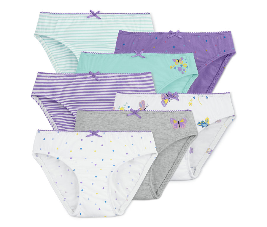 Sieben Slips in verschiedenen Farben und Mustern, darunter Streifen, Punkte und Schmetterlinge.