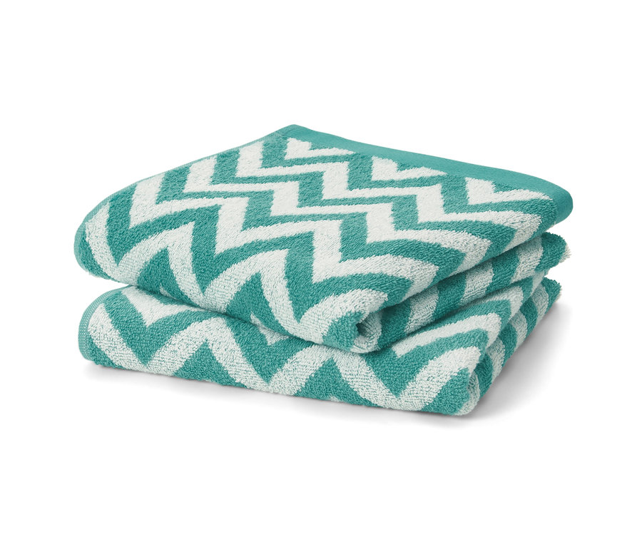 Zwei aqua Jacquard-Handtücher sind aufeinander gestapelt.