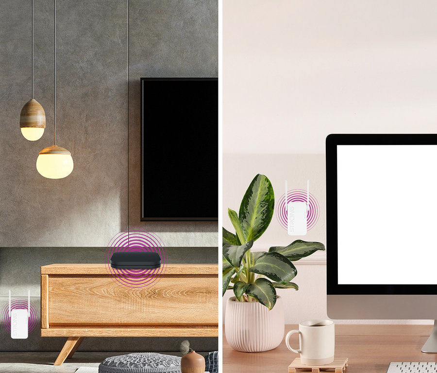 Wohn- und Arbeitsbereich mit schwarzem Strong Wi-Fi 6 Repeater »AX 1800« auf einer Holzkommode.
