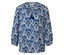 Bluse mit blau-weißem Muster und Troddel-Detail.