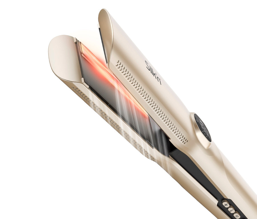 Nahaufnahme eines geöffneten, goldenen Silk'n Glätteisens, das Wärme abstrahlt.