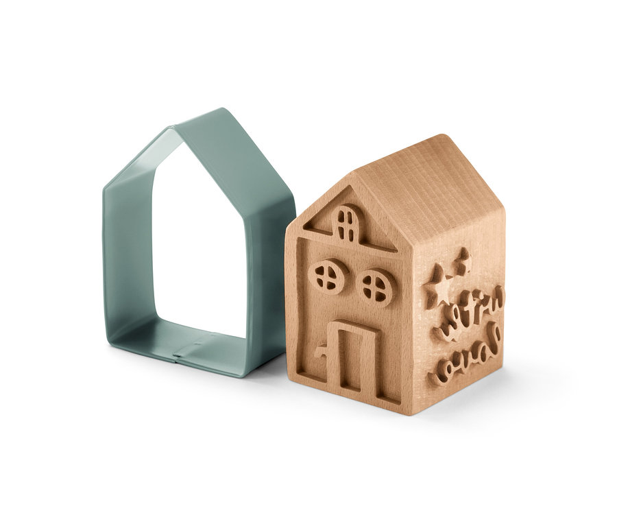 Ein Keksstempel-Set mit einem Haus-Ausstecher und einem Holzstempel.