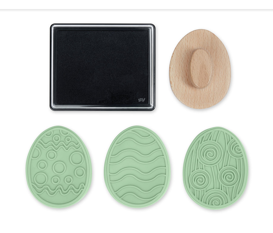 Ein schwarzes Stempelkissen, ein Holzgriff und drei hellgrüne Stempel in Form von Ostereiern mit verschiedenen Mustern.