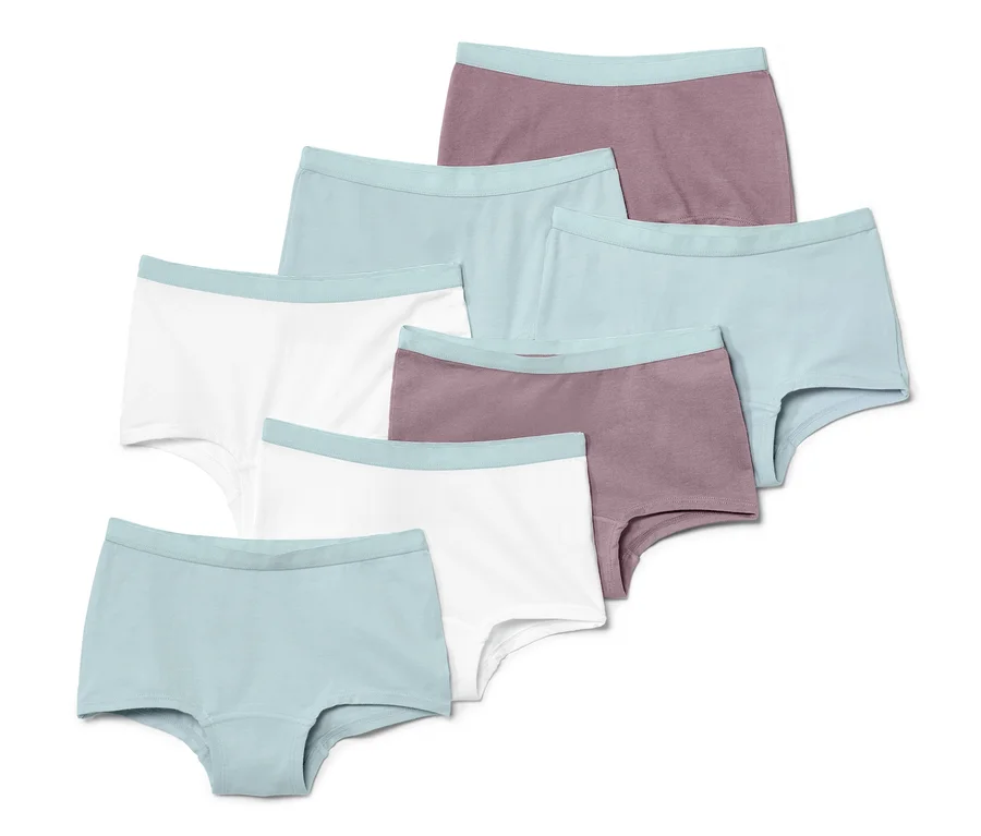Sieben Kinder-Pantys in Weiß, Mauve und Hellblau.