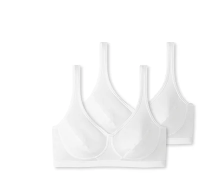 Zwei weiße SCHIESSER Bustiers mit Cups und Bio-Baumwolle liegen nebeneinander.