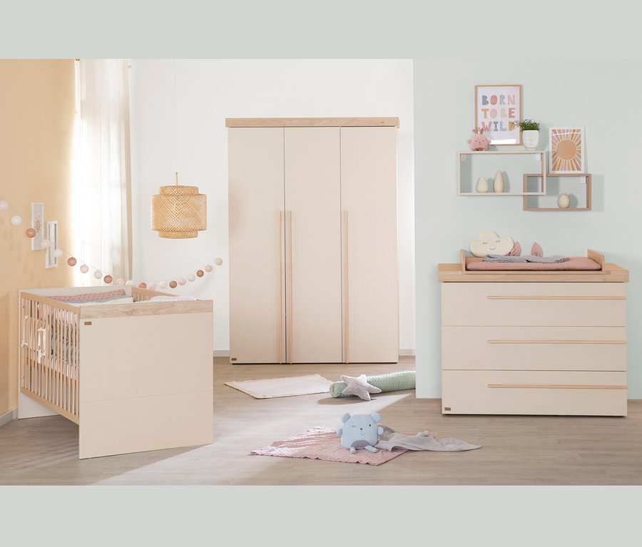 Ein Kinderzimmer mit Gitterbett, Schrank und Kommode. An der Wand befindet sich ein roba Wandregal, cashmere und Dekoration.