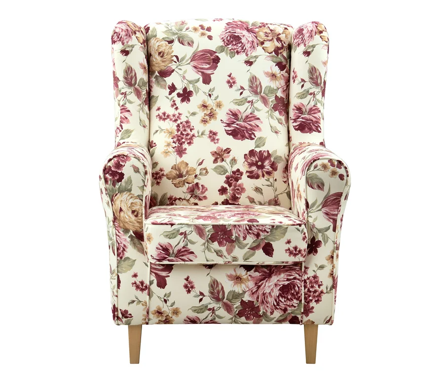 Ohrensessel »Luke« mit cremefarbenem Stoffbezug und floralem Muster aus roten, rosa und goldenen Blüten.