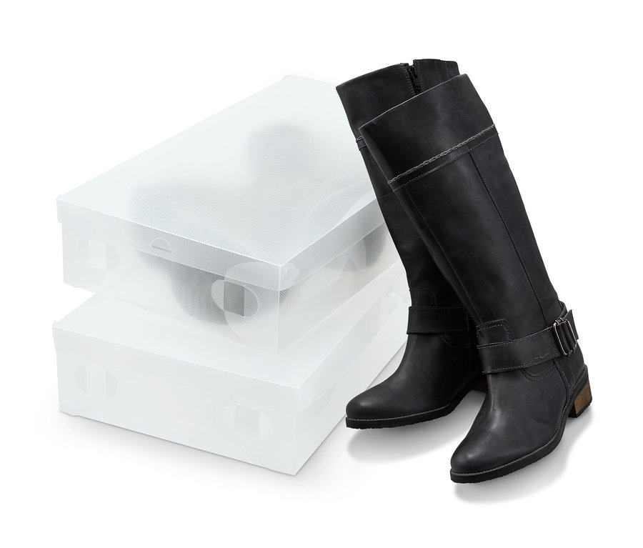 Schwarze Stiefel stehen neben zwei Stiefelaufbewahrungsboxen.