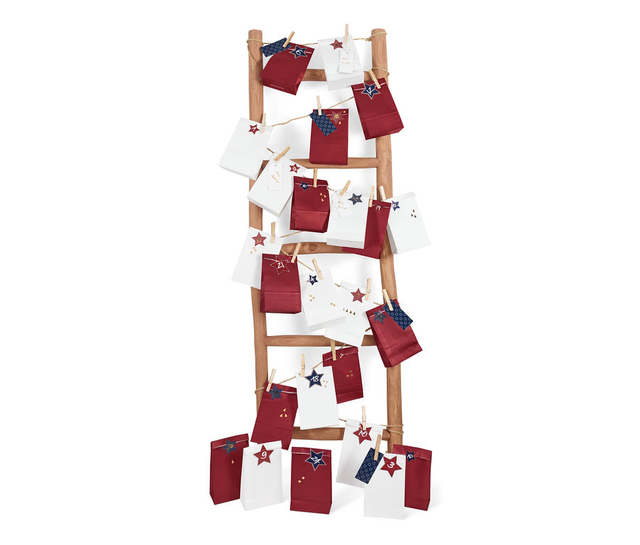 Adventskalender-und-Geschenktüten-Set hängt an einer Holzleiter.
