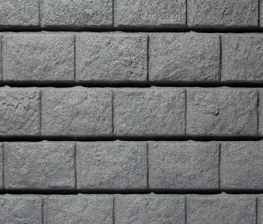 Nahaufnahme der Textur einer grauen Steinwand.