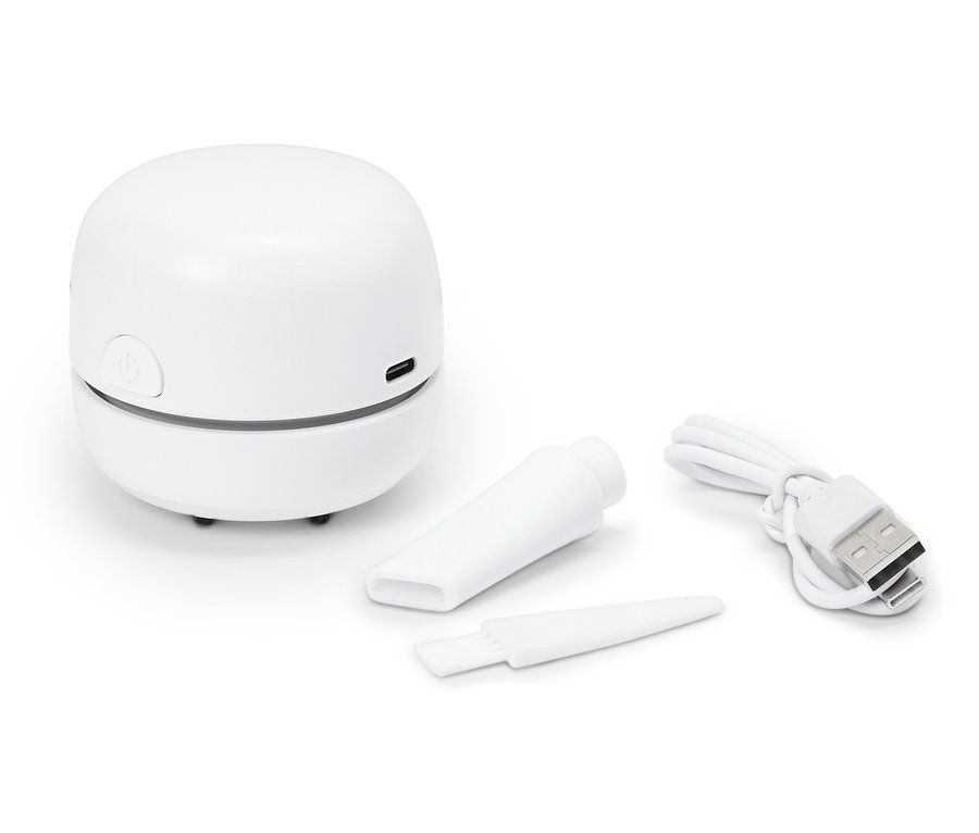 Ein weißer Mini-Staubsauger mit Aufsätzen und einem USB-Kabel.