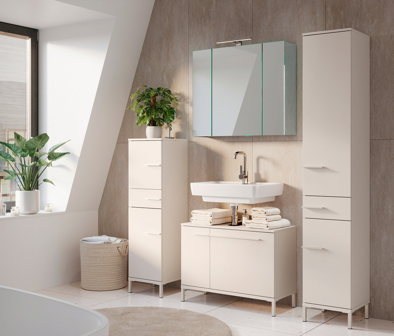 Ein Badezimmer mit einem großen Spiegelschrank »Tavira«, einem Waschbecken, zwei Hochschränken und Pflanzen.
