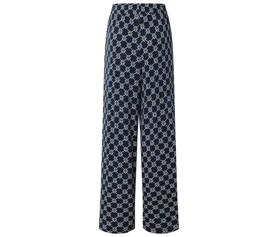 Eine lange, marineblaue Hose mit einem weißen, sich wiederholenden Muster.