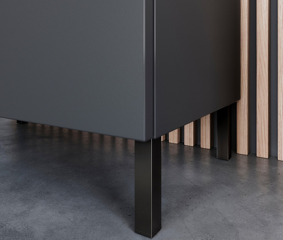 Detailaufnahme eines grauen Schranks mit Metallfüßen auf einem grauen Boden.