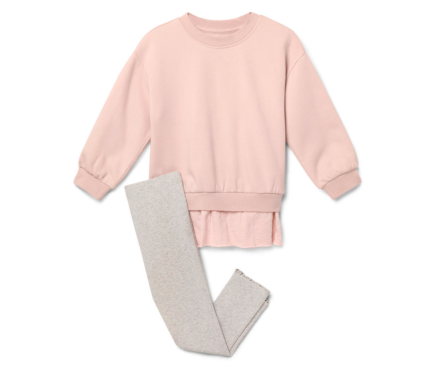 Ein rosa Pullover liegt neben grauen Leggings.
