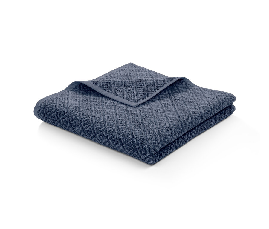 Gefaltetes Jacquard-Badetuch mit geometrischem Muster.