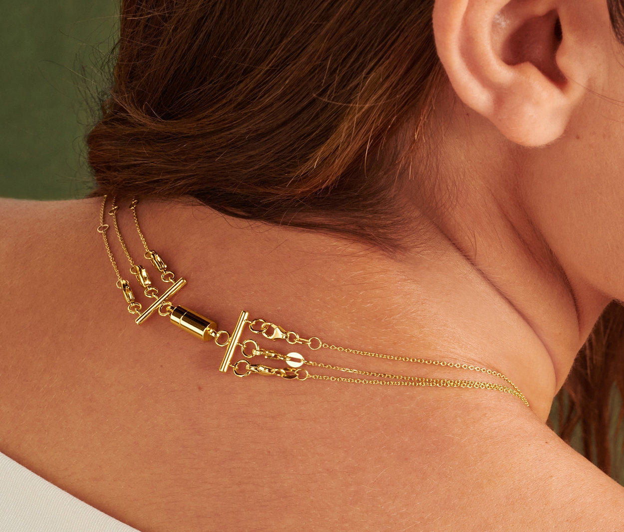 Frau trägt 2 Kettenverschlüsse für Layering.