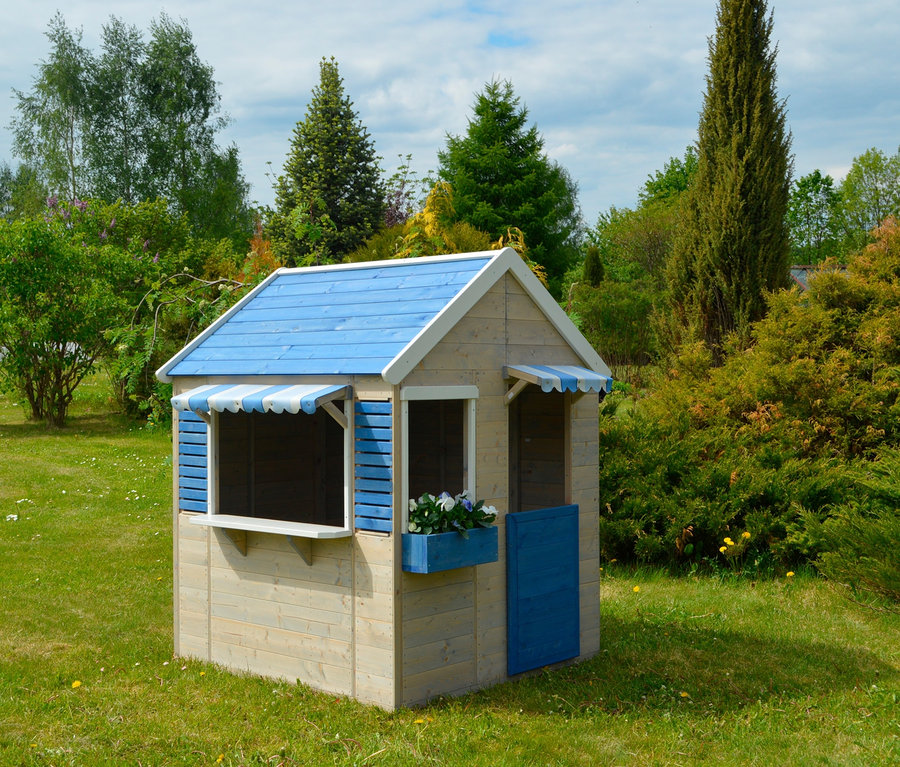Ein kleines hölzernes Wendi-Spielhaus »Maritime House« mit blauem Dach und Fensterläden steht auf einer Wiese.