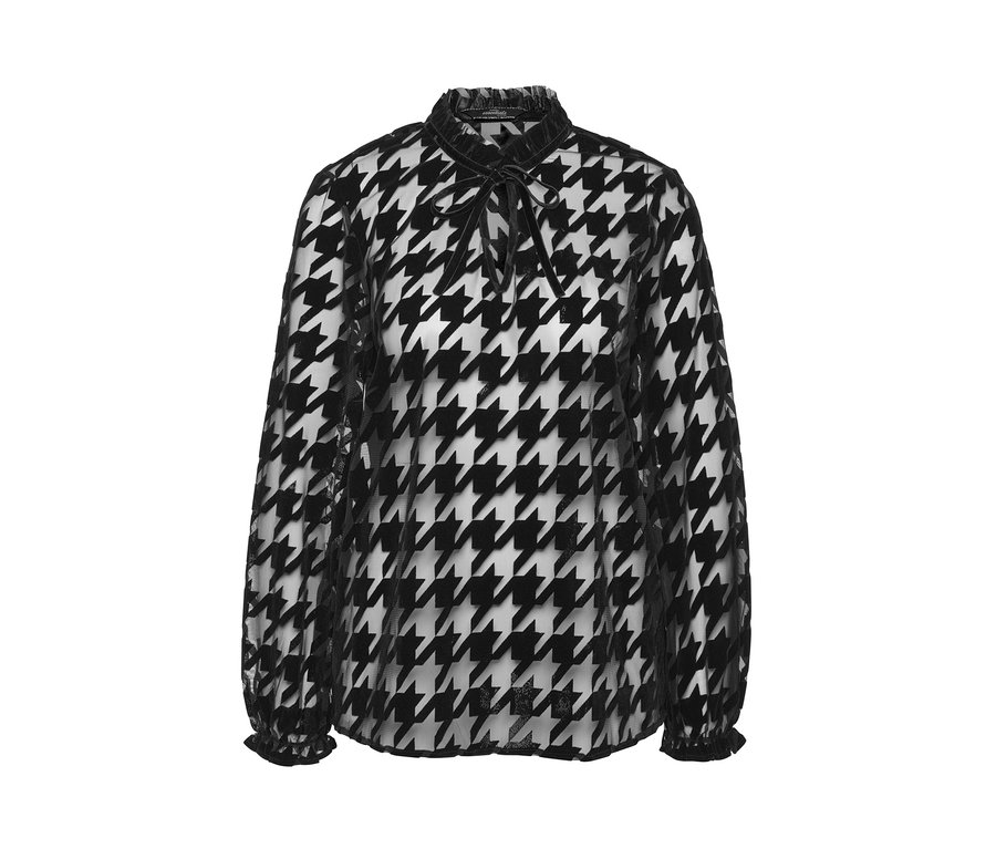 Eine schwarz-weiße Mesh-Bluse mit Hahnentrittmuster, langen Ärmeln und einem Bindeband am Hals.