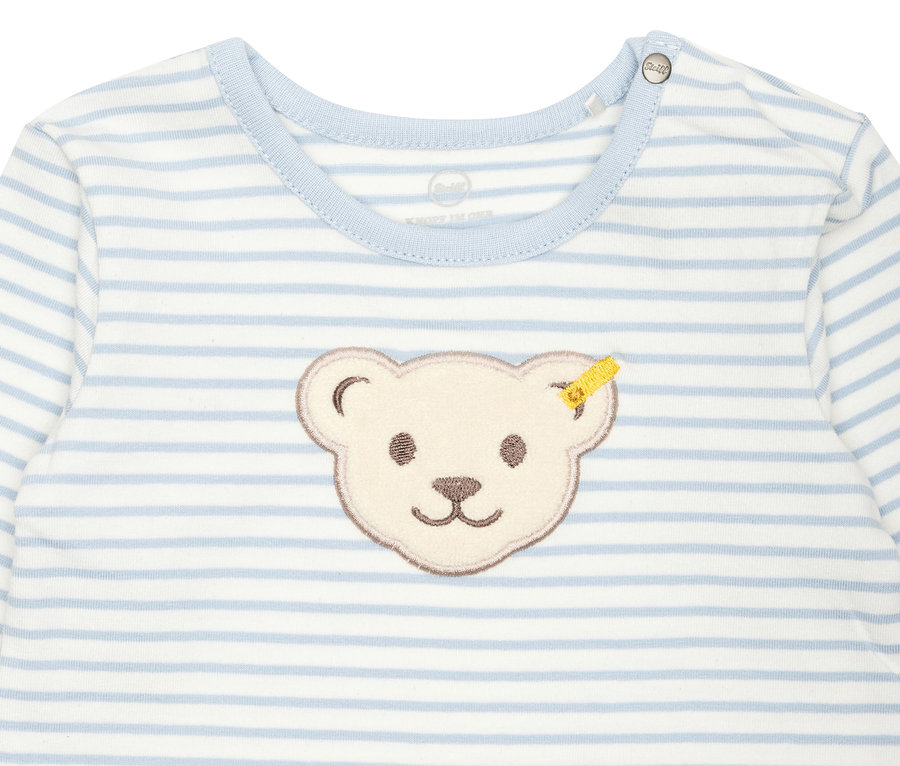 Detailansicht eines blau gestreiften Steiff Baby-Stramplers mit Teddybärmotiv.