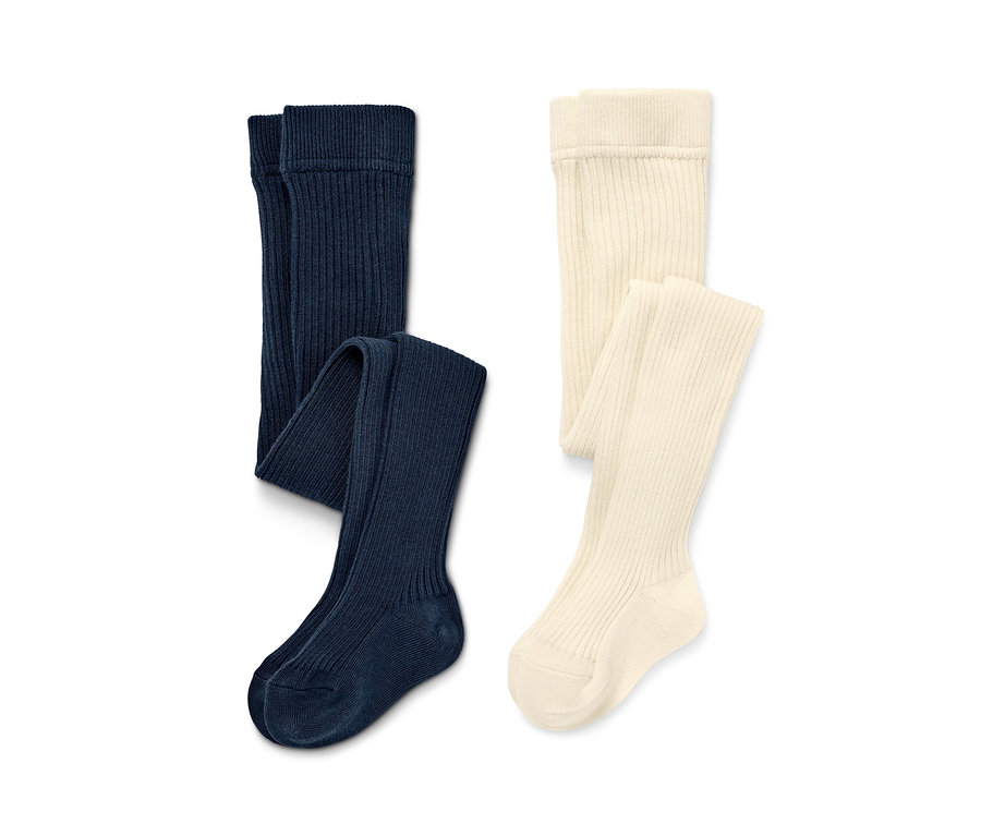 Zwei einfarbige Kinder-Strumpfhosen: marineblau und creme.