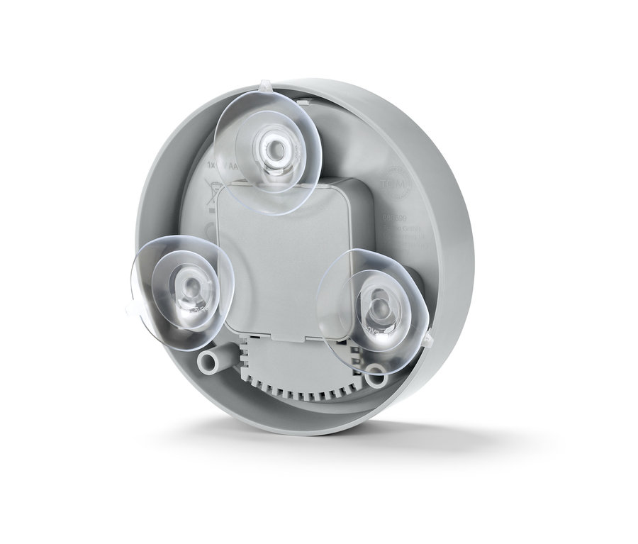 Nahaufnahme der Rückseite einer Badwanduhr mit drei transparenten Saugnäpfen.