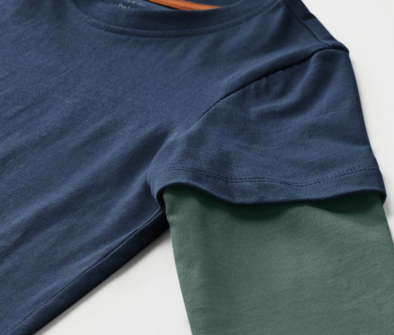 Detailansicht eines blaugrünen 2 Kinder-2-in1-Langarmshirts.