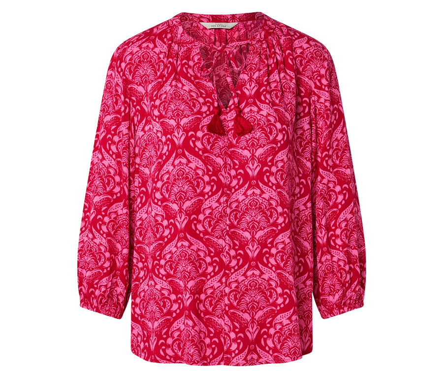 Rote Bluse mit rosa Blumenmuster und Quasten am Halsausschnitt.